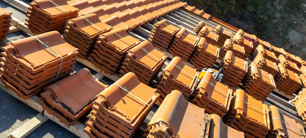 stacks-of-yellow-ceramic-roofing-tiles-for-covering-residential-building-roof-under-construction.jpg